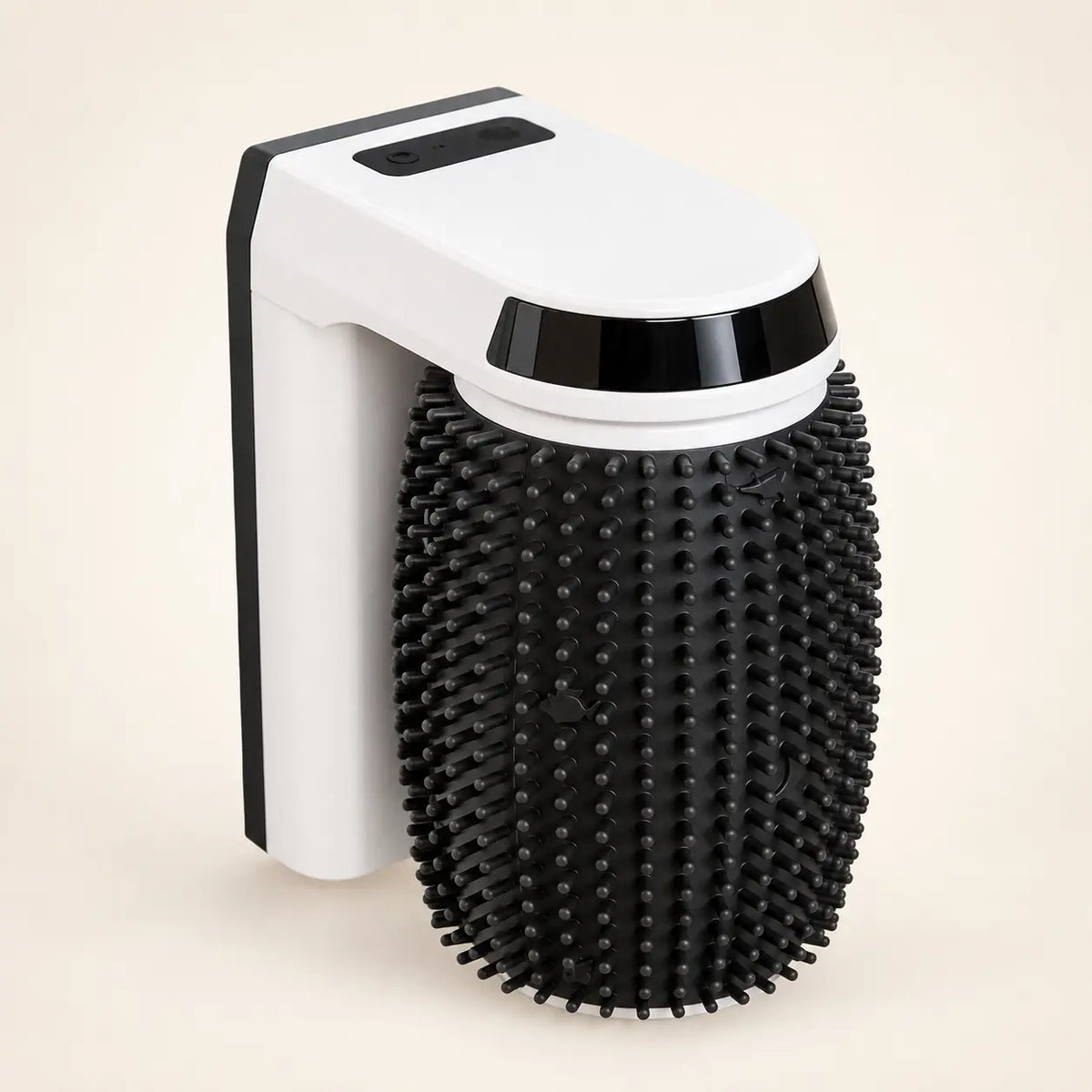 White automatic cat grooming brush with a black rotating silicone roller on an ivory background