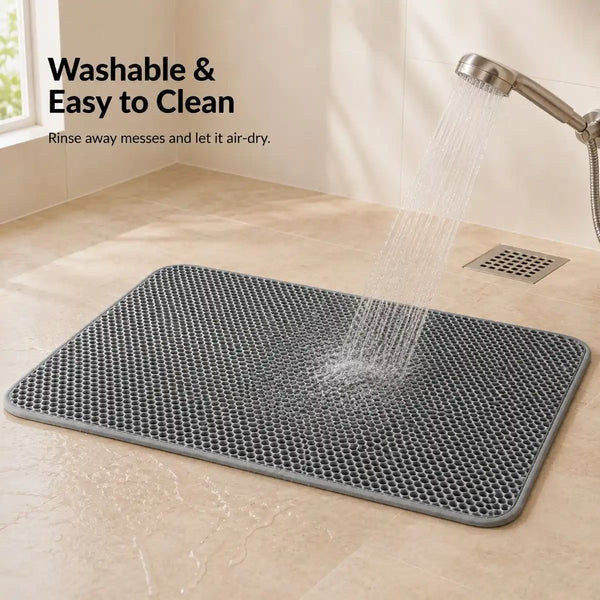 Gray washable cat litter mat being rinsed clean with water